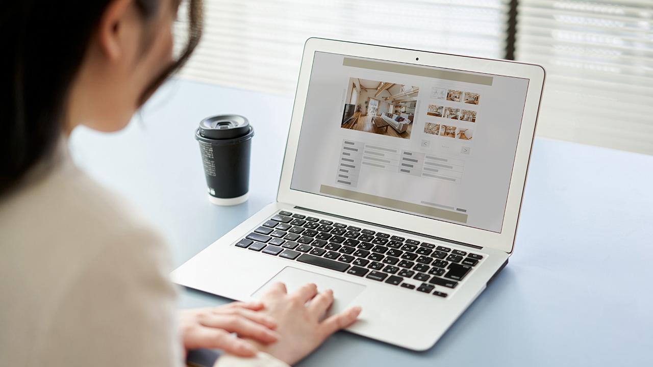 Business owner researching SEO strategies on a laptop, exploring if SEO is worth it for small business growth.