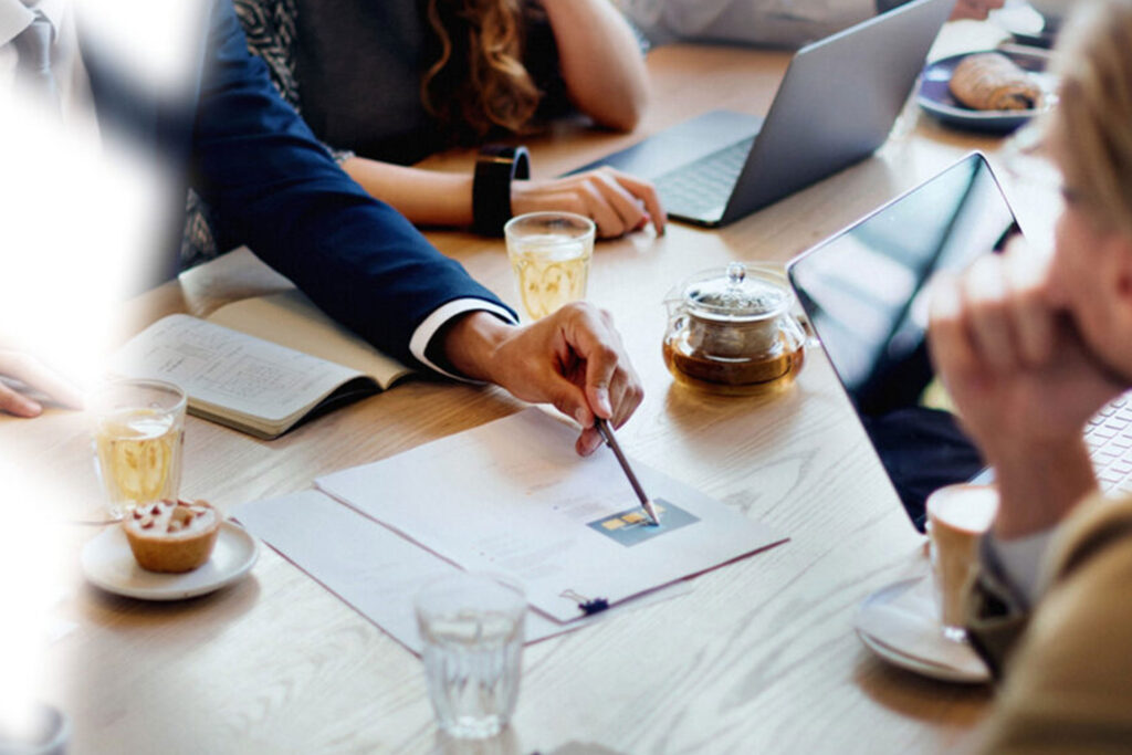 Team strategizing during a business meeting, discussing marketing and personal branding tips to build a successful brand identity.
